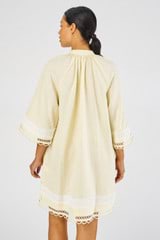 Profile view of model wearing the Oroton Loop Detail Smock Dress in Lemon Curd and 100% linen for Women