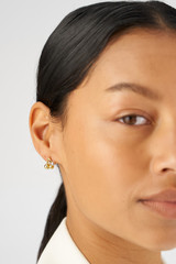 Profile view of model wearing the Oroton Sphere Charm Studs in 18K Gold/Silver and Sustainably sourced 925 Sterling Silver for Women