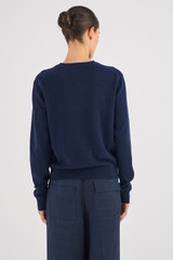 Profile view of model wearing the Oroton Long Sleeve Cashmere Crew Knit in North Sea and 100% Cashmere for Women
