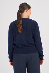 Profile view of model wearing the Oroton Long Sleeve Cashmere Crew Knit in North Sea and 100% Cashmere for Women