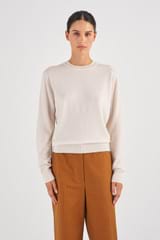 Profile view of model wearing the Oroton Long Sleeve Cashmere Crew Knit in Meringue and 100% Cashmere for Women