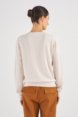 Profile view of model wearing the Oroton Long Sleeve Cashmere Crew Knit in Meringue and 100% Cashmere for Women
