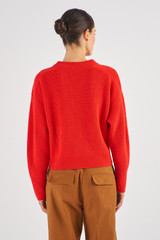 Profile view of model wearing the Oroton Merino Ribbed Crew Knit in Poppy and 100% Merino Wool for Women