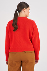 Profile view of model wearing the Oroton Merino Ribbed Crew Knit in Poppy and 100% Merino Wool for Women