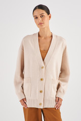 Profile view of model wearing the Oroton Merino Long Line Cardi in Meringue and 100% Merino Wool for Women