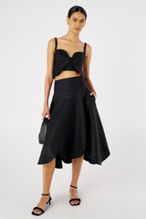 Profile view of model wearing the Oroton Scallop Bodice Top in Black and 100% Linen for Women