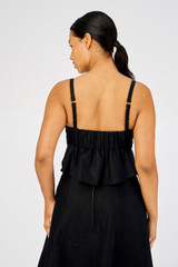 Profile view of model wearing the Oroton Scallop Bodice Top in Black and 100% Linen for Women