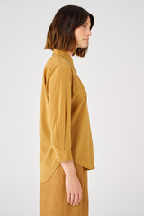 Profile view of model wearing the Oroton Stretch Silk 3/4 Sleeve Shirt in Brown and 92% silk, 8% spandex for Women