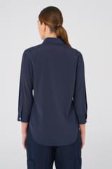 Profile view of model wearing the Oroton Stretch Silk 3/4 Sleeve Shirt in North Sea and 92% Silk, 8% Spandex for Women