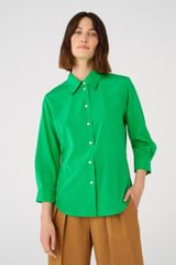 Profile view of model wearing the Oroton Stretch Silk 3/4 Sleeve Shirt in Jewel Green and 92% silk, 8% spandex for Women