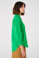 Profile view of model wearing the Oroton Stretch Silk 3/4 Sleeve Shirt in Jewel Green and 92% silk, 8% spandex for Women