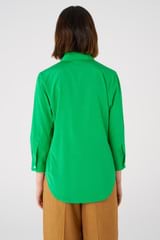 Profile view of model wearing the Oroton Stretch Silk 3/4 Sleeve Shirt in Jewel Green and 92% silk, 8% spandex for Women