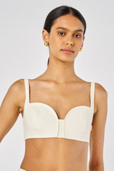Profile view of model wearing the Oroton Bralette in Soft Cream and 100% Linen for Women