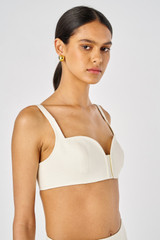 Profile view of model wearing the Oroton Bralette in Soft Cream and 100% Linen for Women