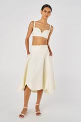 Profile view of model wearing the Oroton Scallop Midi Skirt in Soft Cream and 100% Linen for Women