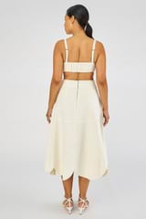 Profile view of model wearing the Oroton Scallop Midi Skirt in Soft Cream and 100% Linen for Women