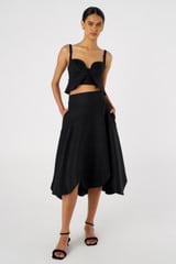 Profile view of model wearing the Oroton Scallop Midi Skirt in Black and 100% Linen for Women