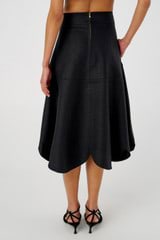 Profile view of model wearing the Oroton Scallop Midi Skirt in Black and 100% Linen for Women