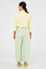 Profile view of model wearing the Oroton Twill Pleat Pant in Eau De Nil and 77% cotton 23% linen for Women