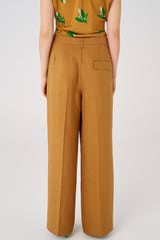 Profile view of model wearing the Oroton Pleat Pant in Toffee and 58% viscose, 42% linen for Women