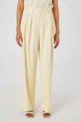 Profile view of model wearing the Oroton Pleat Pant in Lemon Curd and 81% viscose, 17% cotton, 2% elastane for Women