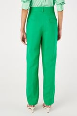 Profile view of model wearing the Oroton Pleat Pant in Jewel Green and 58% viscose, 42% linen for Women