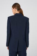 Profile view of model wearing the Oroton Double Breasted Blazer in North Sea and 58% Viscose, 42% Linen for Women