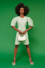 Profile view of model wearing the Oroton Short Utility Dress in Eau De Nil and 77% cotton, 23% linen for Women