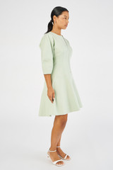 Profile view of model wearing the Oroton Short Utility Dress in Eau De Nil and 77% cotton, 23% linen for Women