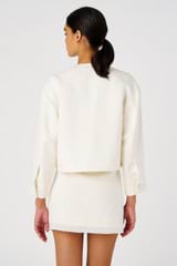 Profile view of model wearing the Oroton Crop Jacket in Cream and 58% Viscose, 42% Linen for Women