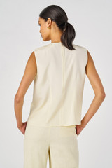 Profile view of model wearing the Oroton Disc Fringe Top in Lemon Curd and 93% silk, 7% spandex for Women