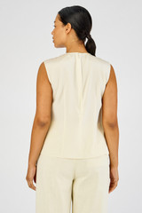 Profile view of model wearing the Oroton Disc Fringe Top in Lemon Curd and 93% silk, 7% spandex for Women