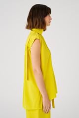 Profile view of model wearing the Oroton Sleeveless High Neck Top in Vivid Yellow and 92% silk, 8% spandex for Women