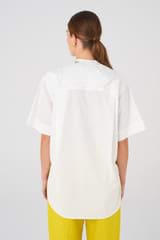 Profile view of model wearing the Oroton Cotton Camp Shirt in White and 100% Cotton for Women