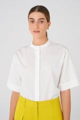Profile view of model wearing the Oroton Cotton Camp Shirt in White and 100% Cotton for Women