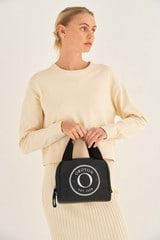 Profile view of model wearing the Oroton KAIA LUNCH BAG in Black and Recycled Canvas With Coating for Women