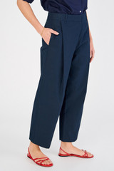 Profile view of model wearing the Oroton Twill Pleat Pant in North Sea and 77% cotton 23% linen for Women