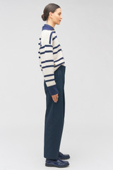 Profile view of model wearing the Oroton Twill Pleat Pant in North Sea and 77% cotton 23% linen for Women