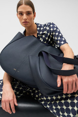 Profile view of model wearing the Oroton Emilia Large Tote in North Sea and Pebble leather for Women