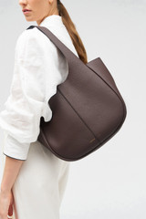 Profile view of model wearing the Oroton Emilia Tote in Bear Brown and Pebble leather for Women