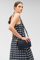 Profile view of model wearing the Oroton Alice Crossbody in North Sea and Pebble leather for Women