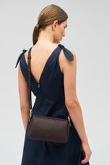 Profile view of model wearing the Oroton Alice Crossbody in Bear Brown and Pebble leather for Women