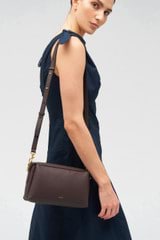 Profile view of model wearing the Oroton Alice Crossbody in Bear Brown and Pebble leather for Women
