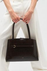 Profile view of model wearing the Oroton Audrey Texture Three Pocket Day Bag in Mahogany and Textured leather for Women