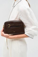 Profile view of model wearing the Oroton Audrey Texture Crossbody in Mahogany and Textured leather for Women
