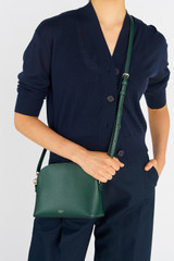 Profile view of model wearing the Oroton Inez Slim Crossbody in Juniper and Saffiano Leather for Women