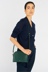 Profile view of model wearing the Oroton Inez Slim Crossbody in Juniper and Saffiano Leather for Women