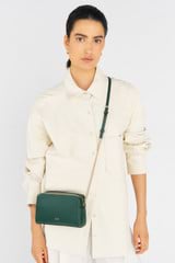 Profile view of model wearing the Oroton Inez Chain Crossbody in Juniper and Saffiano Leather for Women