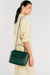 Profile view of model wearing the Oroton Inez Medium Satchel in Juniper and Saffiano Leather for Women