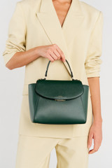 Profile view of model wearing the Oroton Inez Medium Satchel in Juniper and Saffiano Leather for Women